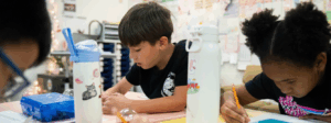 Students sitting at desks work on a worksheet.